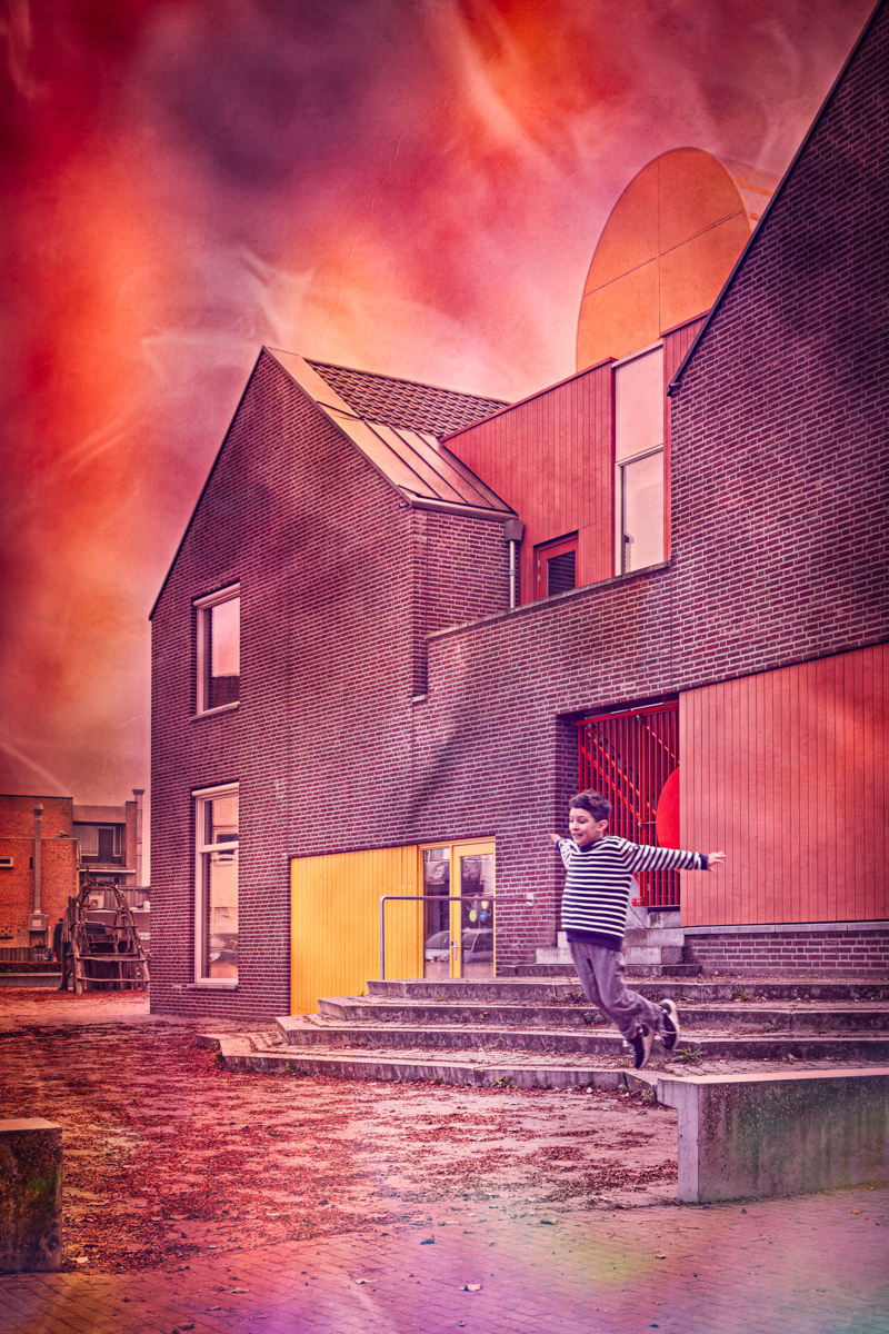 A young boy, in front of a building, jumping off a wall with his arms extended as they were wings. “What if I fall?” “Oh, but my darling, what if you fly?”