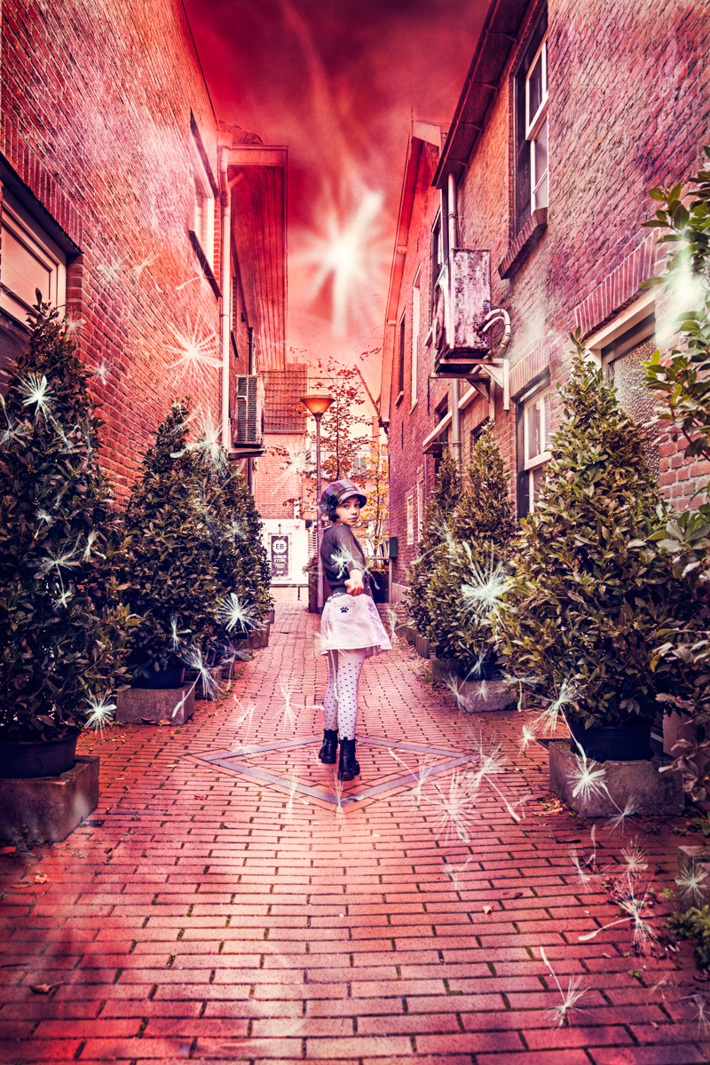 So come with me where dreams are born and time is never planned… A young girl stands in a glowing alleyway lined with trees, reaching out with wonder as sparkling lights dance around her — capturing the enchantment of dreams where time stands still, in a modern Peter Pan-inspired fantasy.