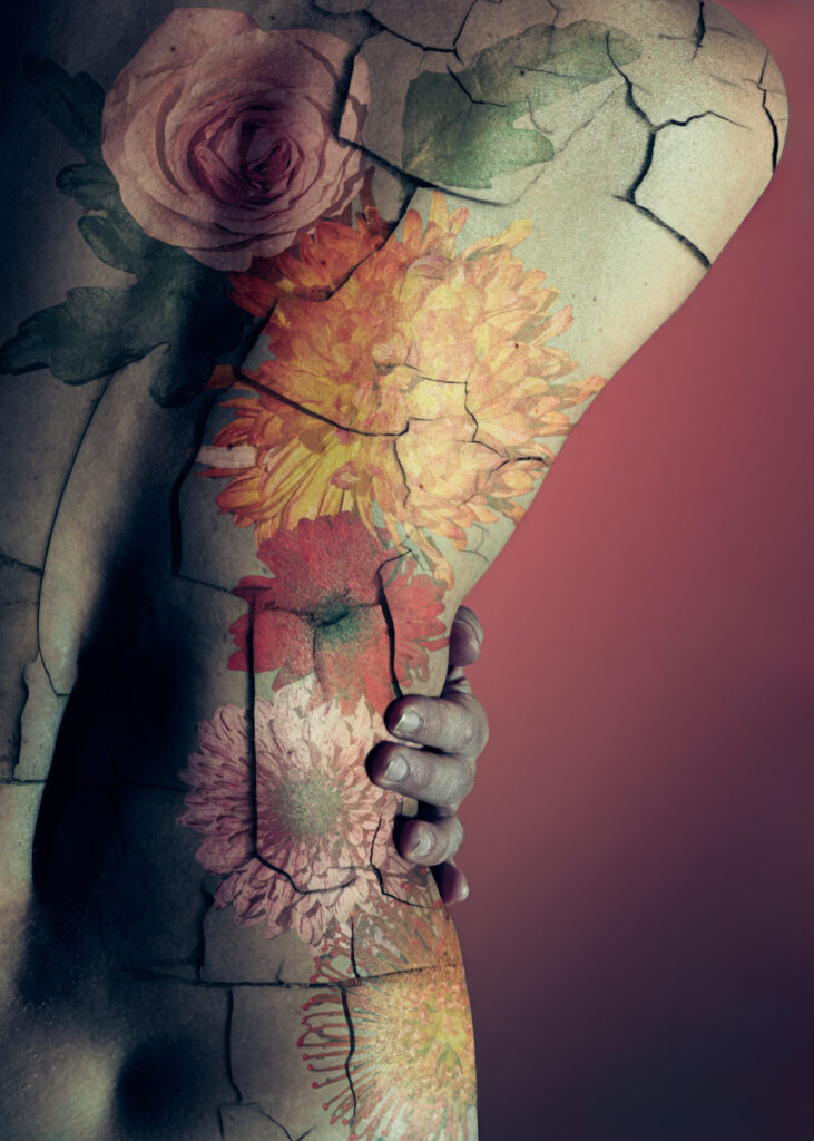 Surreal artwork featuring a fractured surface adorned with watercolor flowers—including roses, chrysanthemums, and others—painted in soft hues, with a hand touching the surface; background transitions from pink to purple.